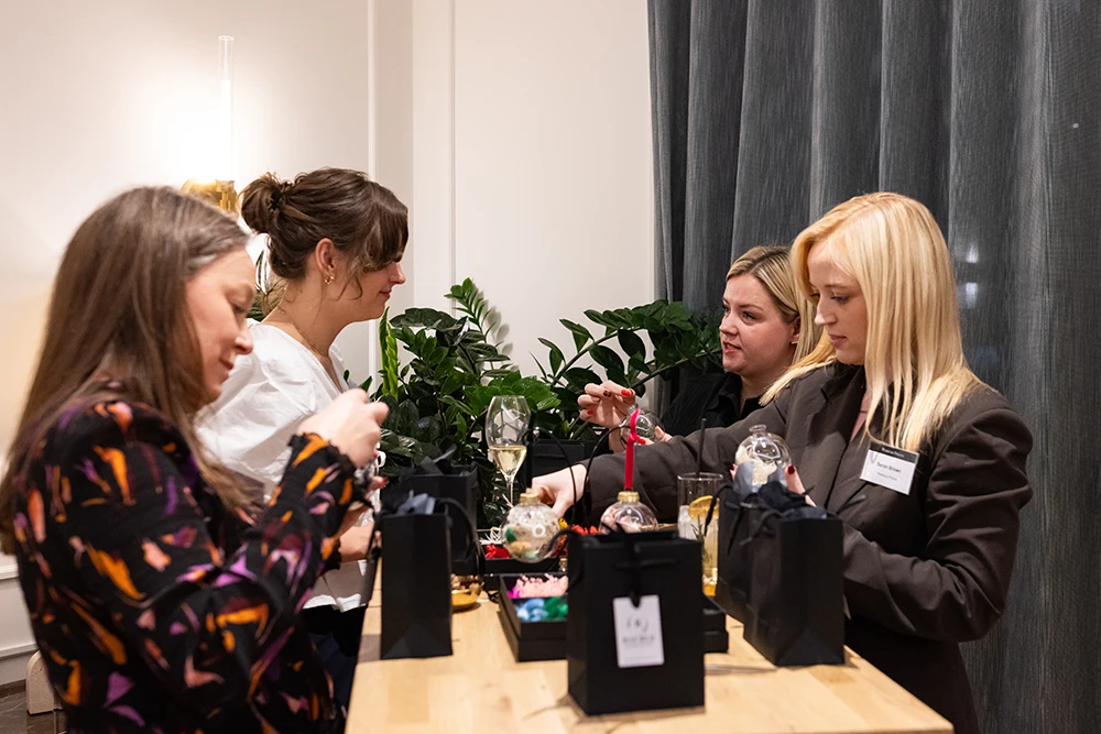 Festive Bauble Bar Guests creating personalised Christmas baubles at a festive drop-in bauble bar