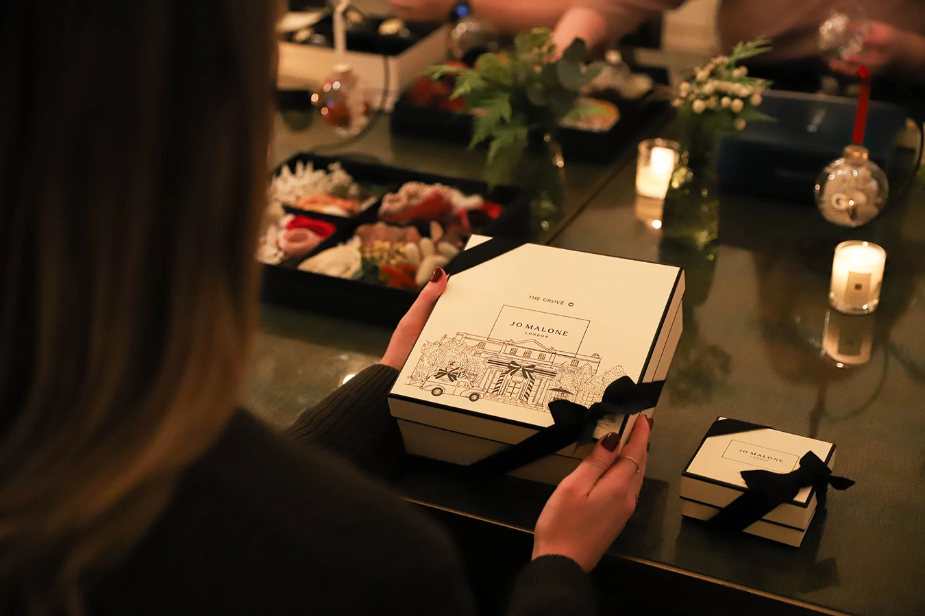 Guest opening a branded Jo Malone London workshop box at The Grove